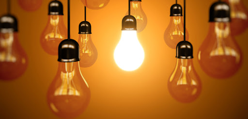 idea concept with light bulbs on a orange background